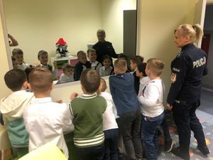 policjantka stoi w pokoju przy grupie dzieci