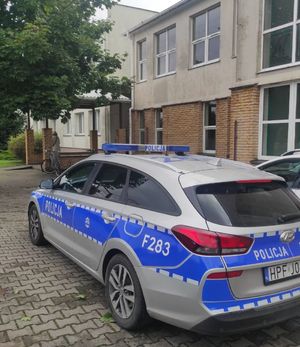 Radiowóz stoi przed szkołą.