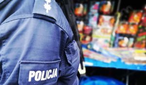 Policjant stoi przy fajerwerkach.