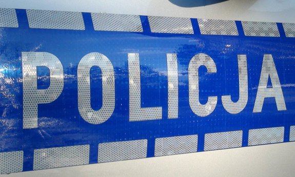 Napis Policja na niebieskim tle.